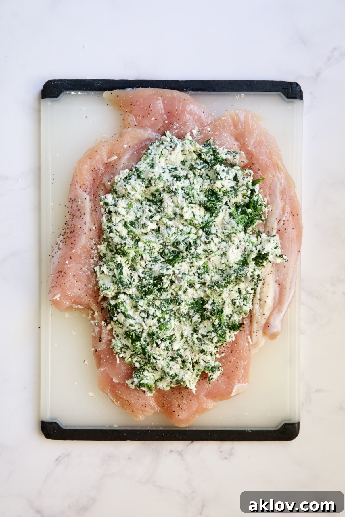Butterflied turkey breast with the spinach and ricotta filling spread over it, before rolling.