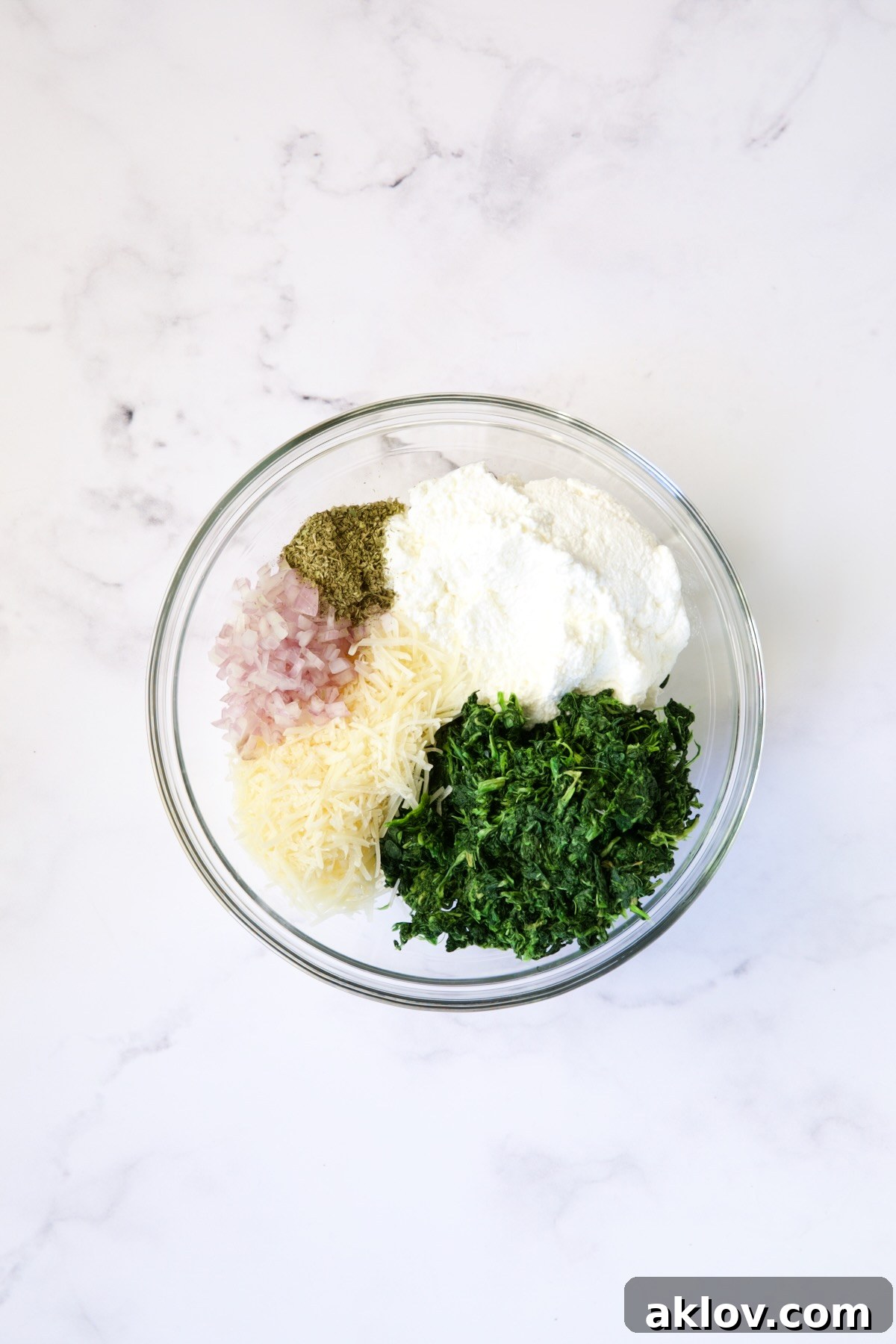 Ingredients for the turkey breast filling, unmixed, in a glass bowl.