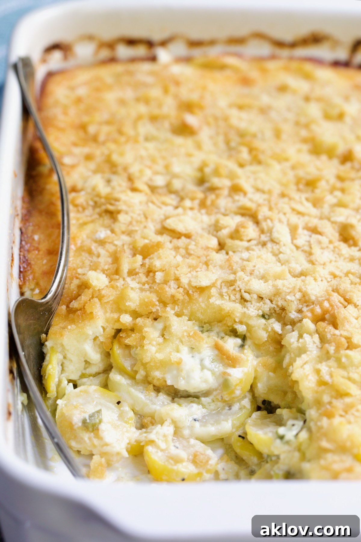 Southwestern Summer Squash Casserole in white baking dish with serving fork.