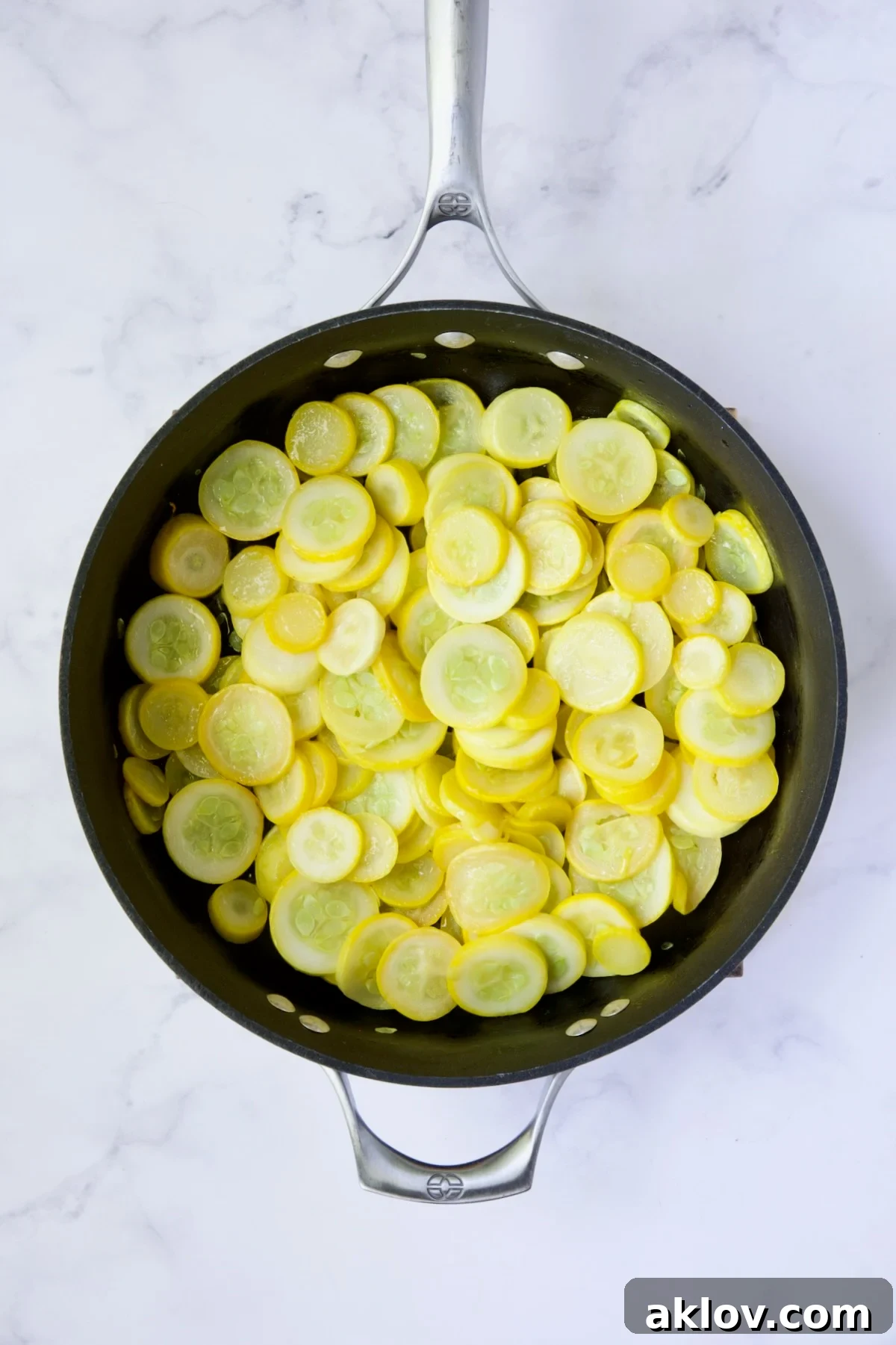 Golden Summer Squash Bake 5 Cooked yellow squash in a nonstick skillet, showing its softened texture.