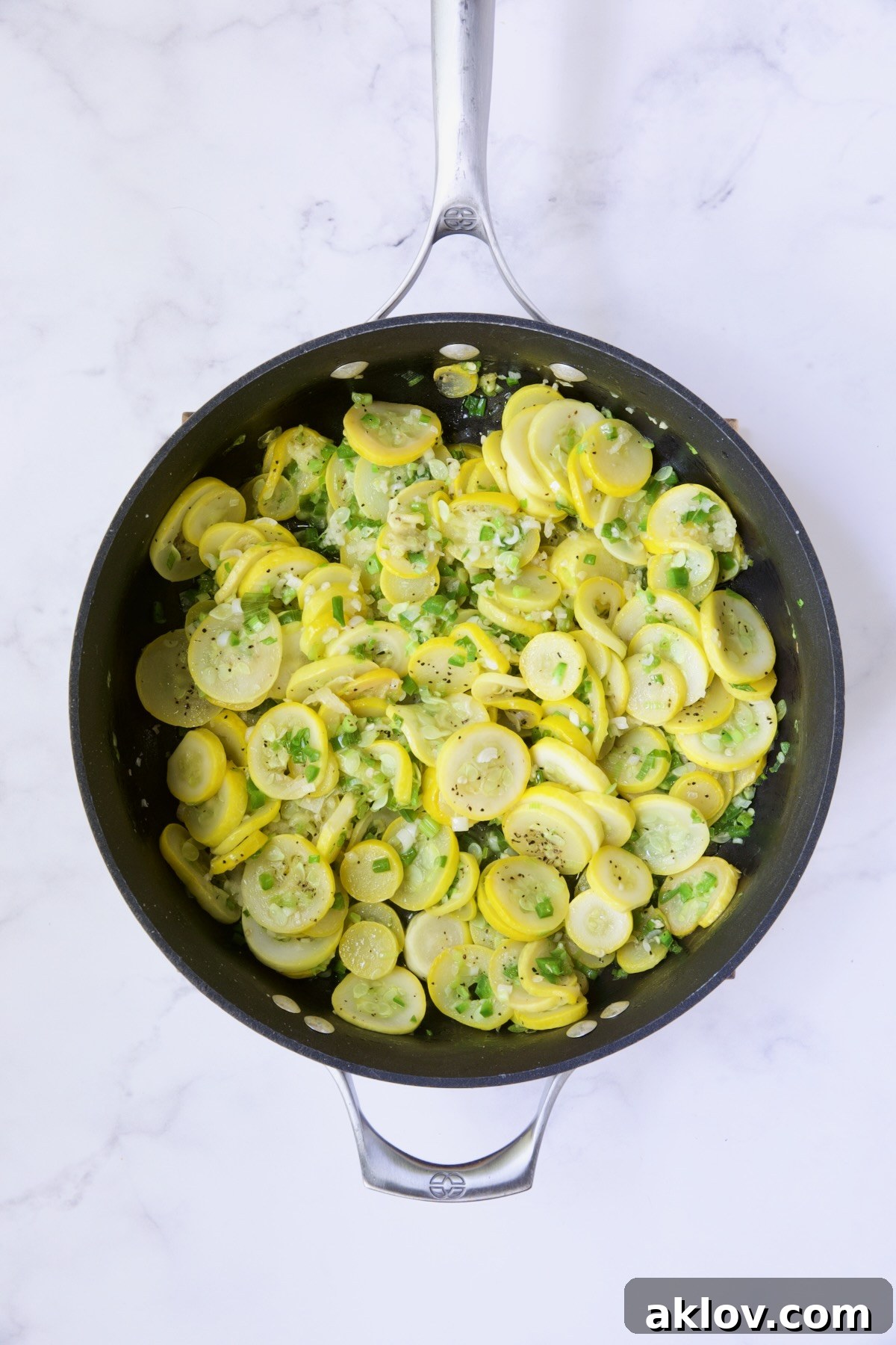 Sauteed yellow / summer squash and scallions in nonstick skillet.