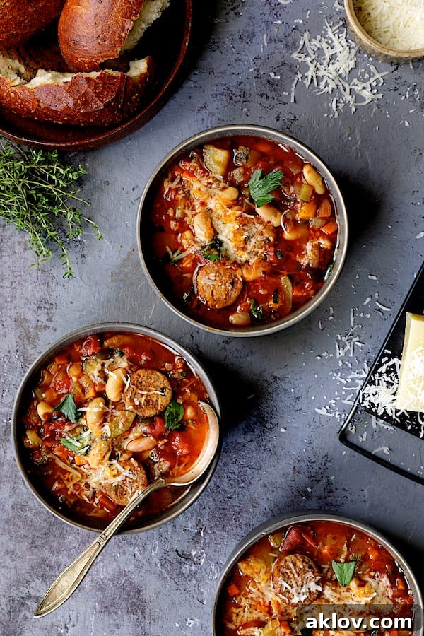 Rustic Chorizo, White Bean and Vegetable Stew 11 Multiple bowls of Chorizo White Bean and Vegetable Soup, artfully arranged with scattered cheese and slices of bread, highlighting its rustic appeal.