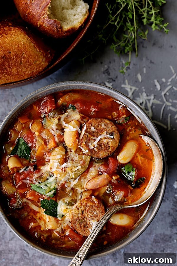 Rustic Chorizo, White Bean and Vegetable Stew 10 A close-up shot of a single bowl of Chorizo White Bean and Vegetable Soup, with a spoon nestled in, inviting a taste.