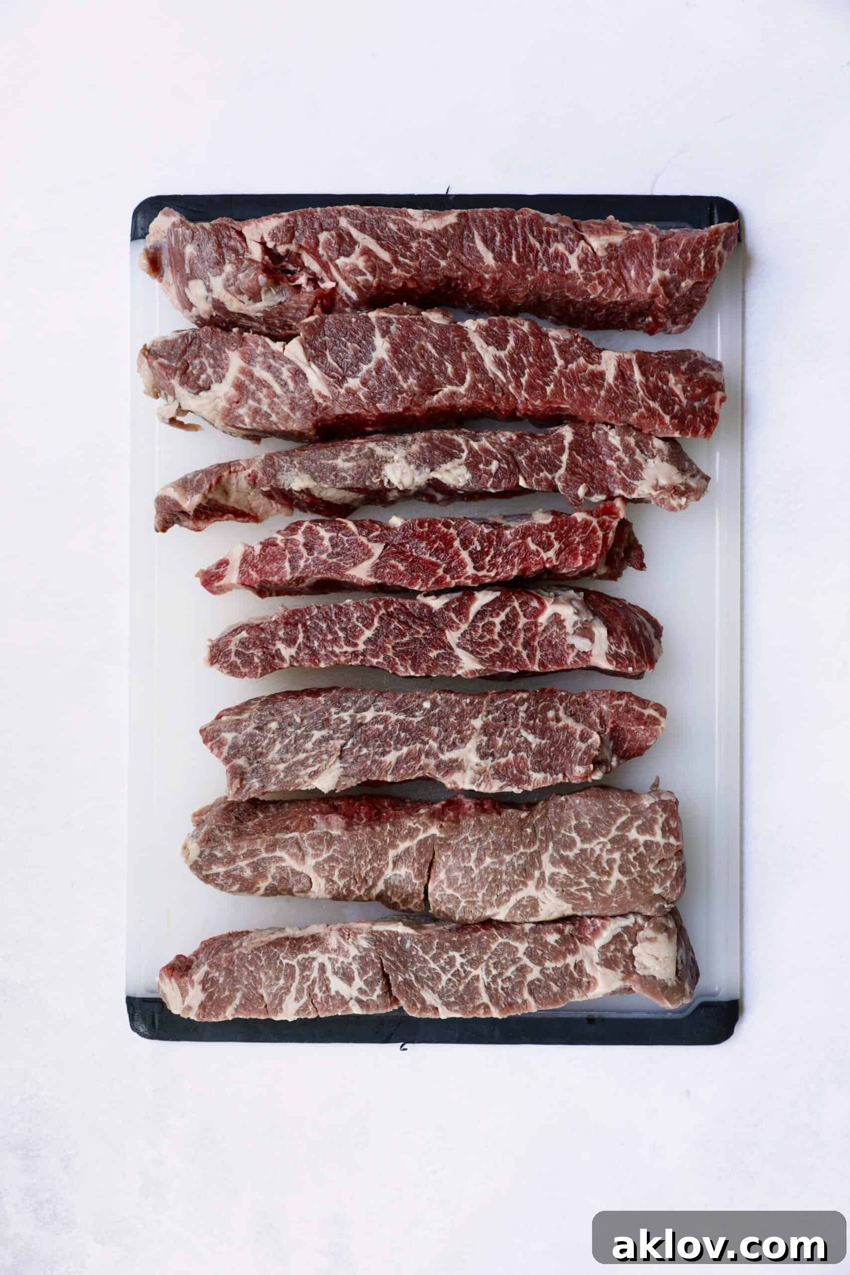Overhead shot of boneless short ribs on white cutting board