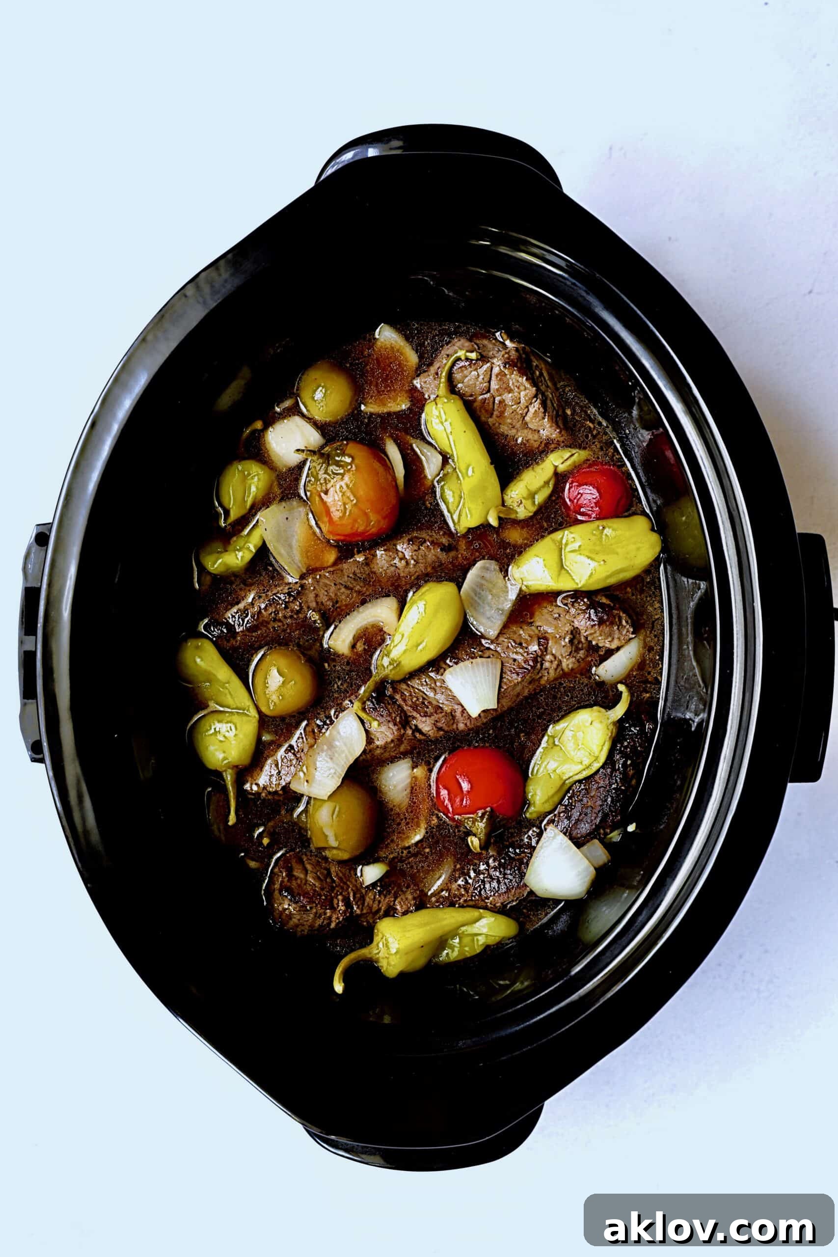 Photo of short ribs in slow cooker before cooking.