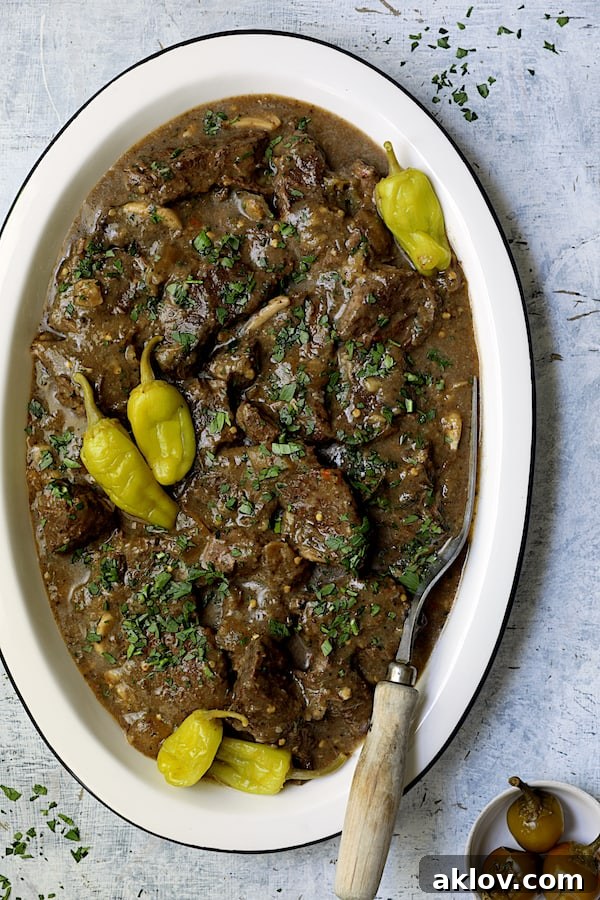 Photo of Mississippi-Style Boneless Short Ribs on white platter with meat fork.