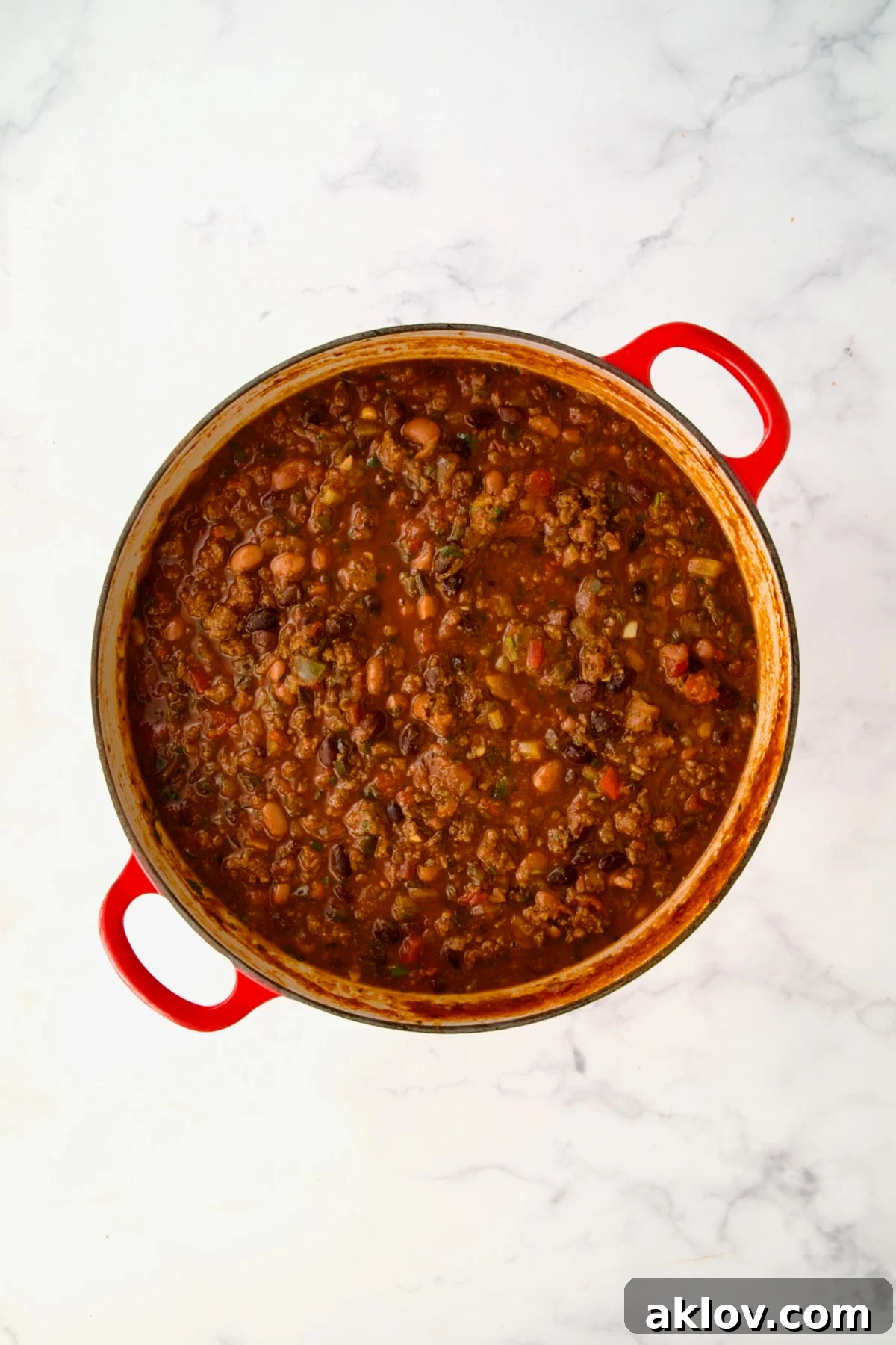 Finished chili in red Dutch oven.