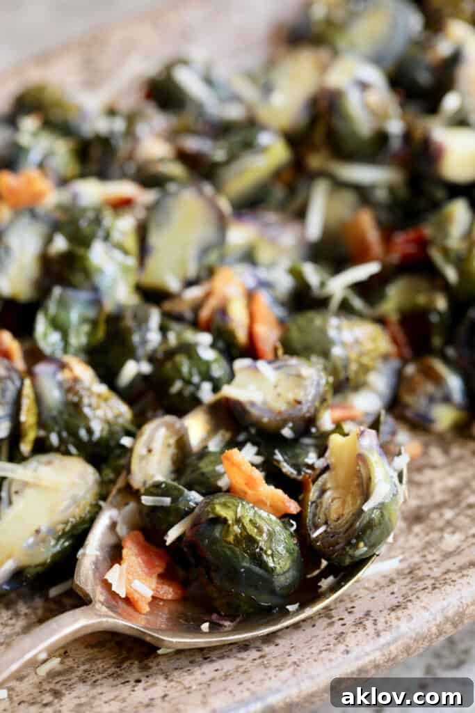 Close-up photo of Roasted Purple Brussels Sprouts with Bacon and Parmesan on serving spoon.