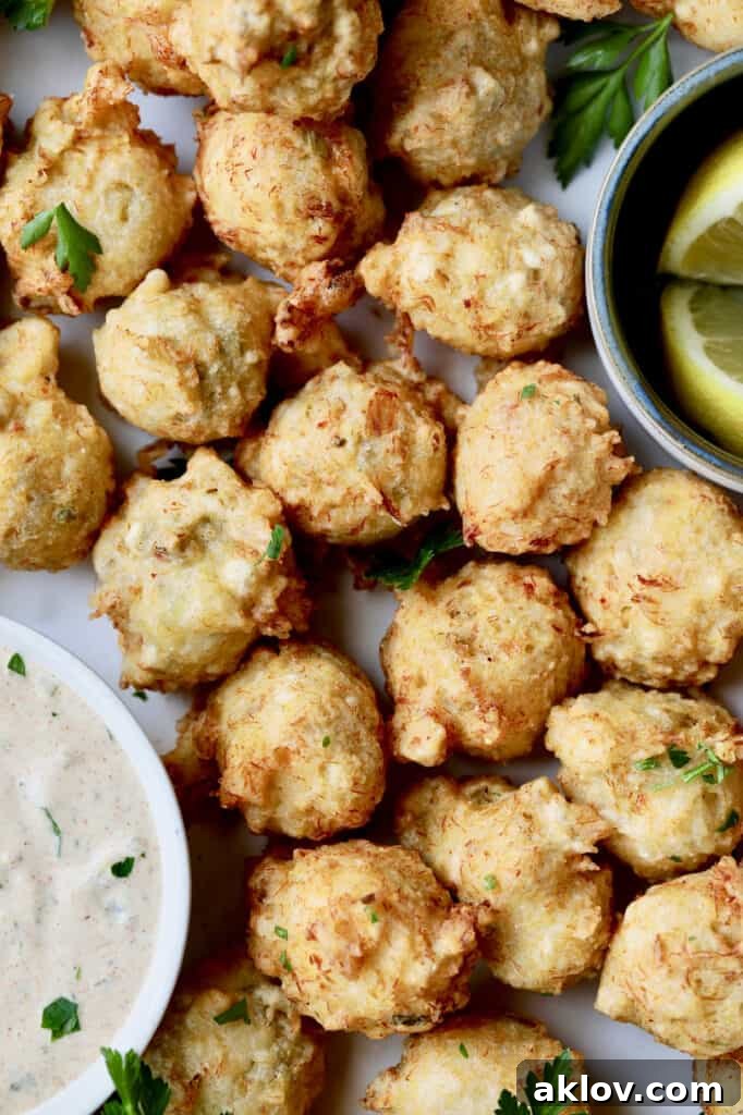 Close-up photo of Crab and Artichoke Beignets with Jalapeno Remoulade, ready to be enjoyed.