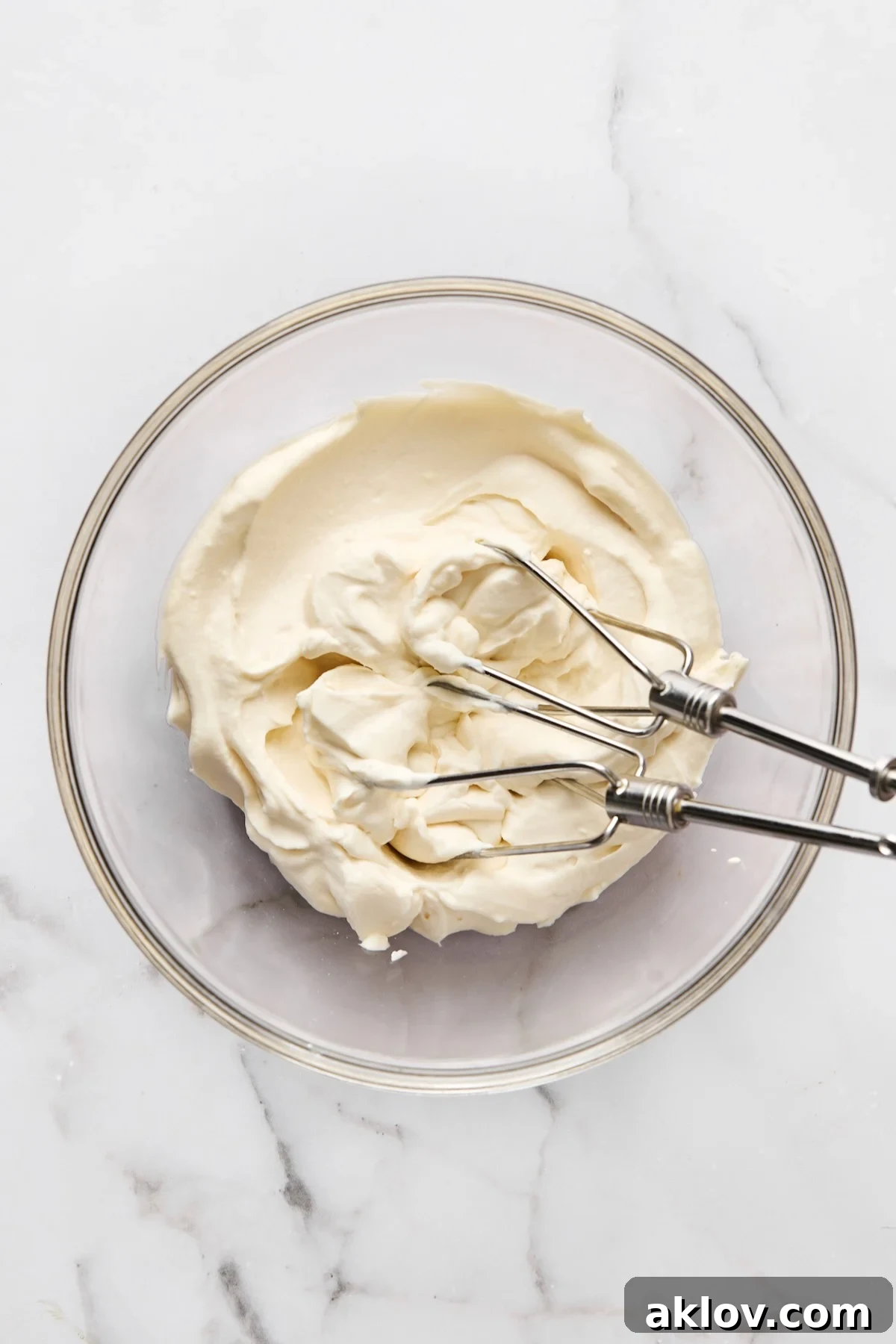 Mascarpone whipped cream in glass bowl.