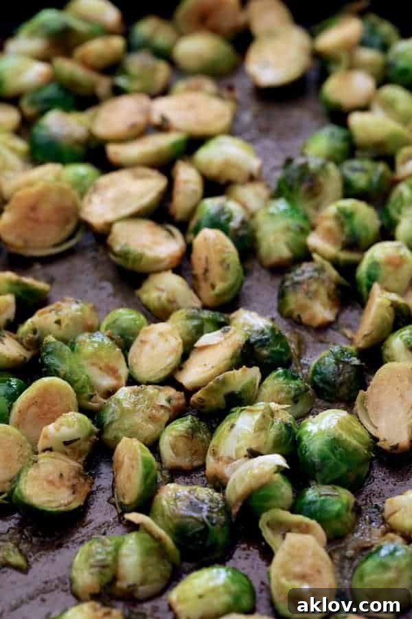 Photo of roasted Brussels sprouts on baking sheet.