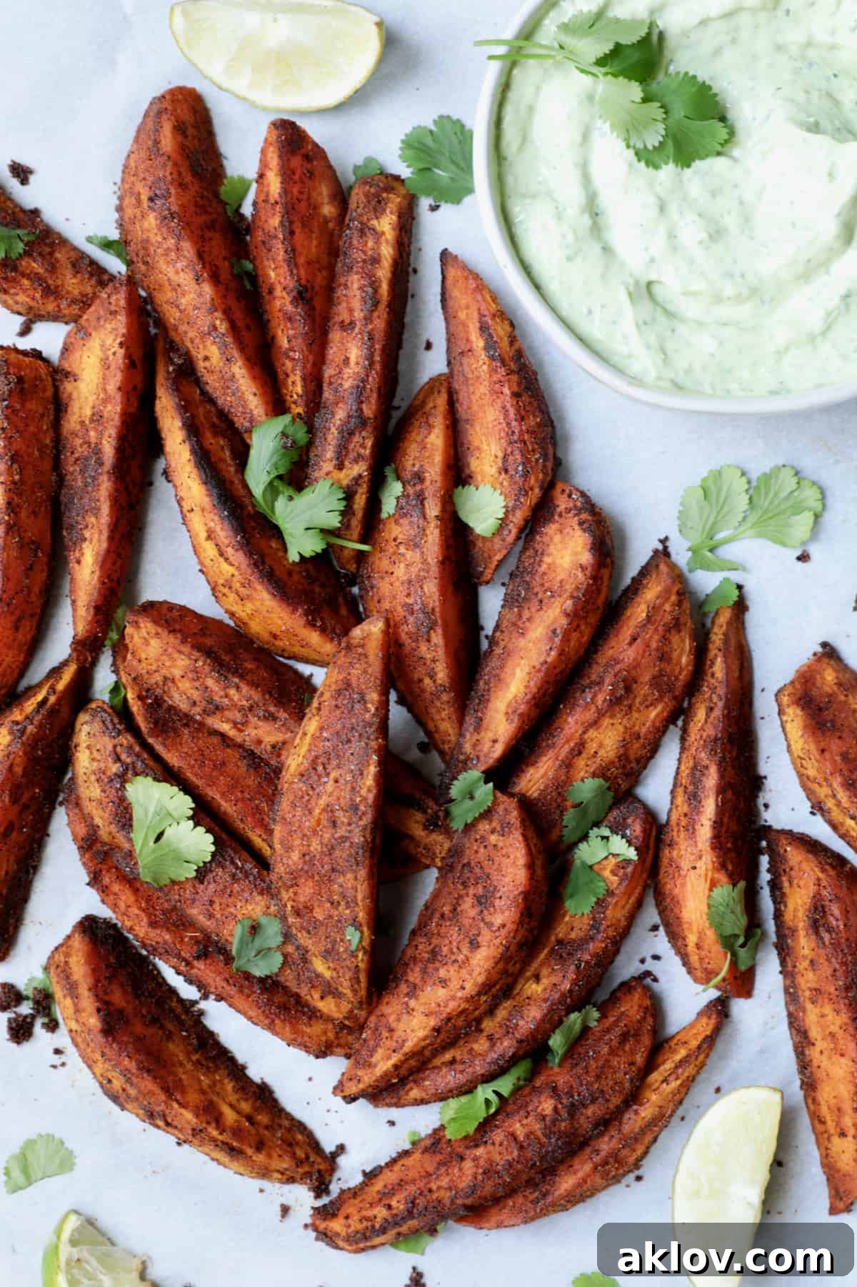 Southwestern Sweet Potato Wedges with Avocado - Cilantro Sour Cream garnished with cilantro.