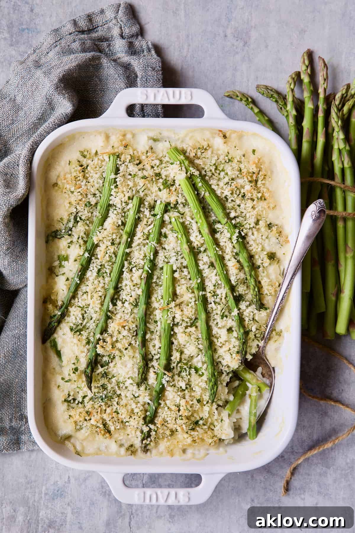 A beautifully presented Creamy Asparagus and Rice Casserole, ready to be served, resting on a gray napkin.