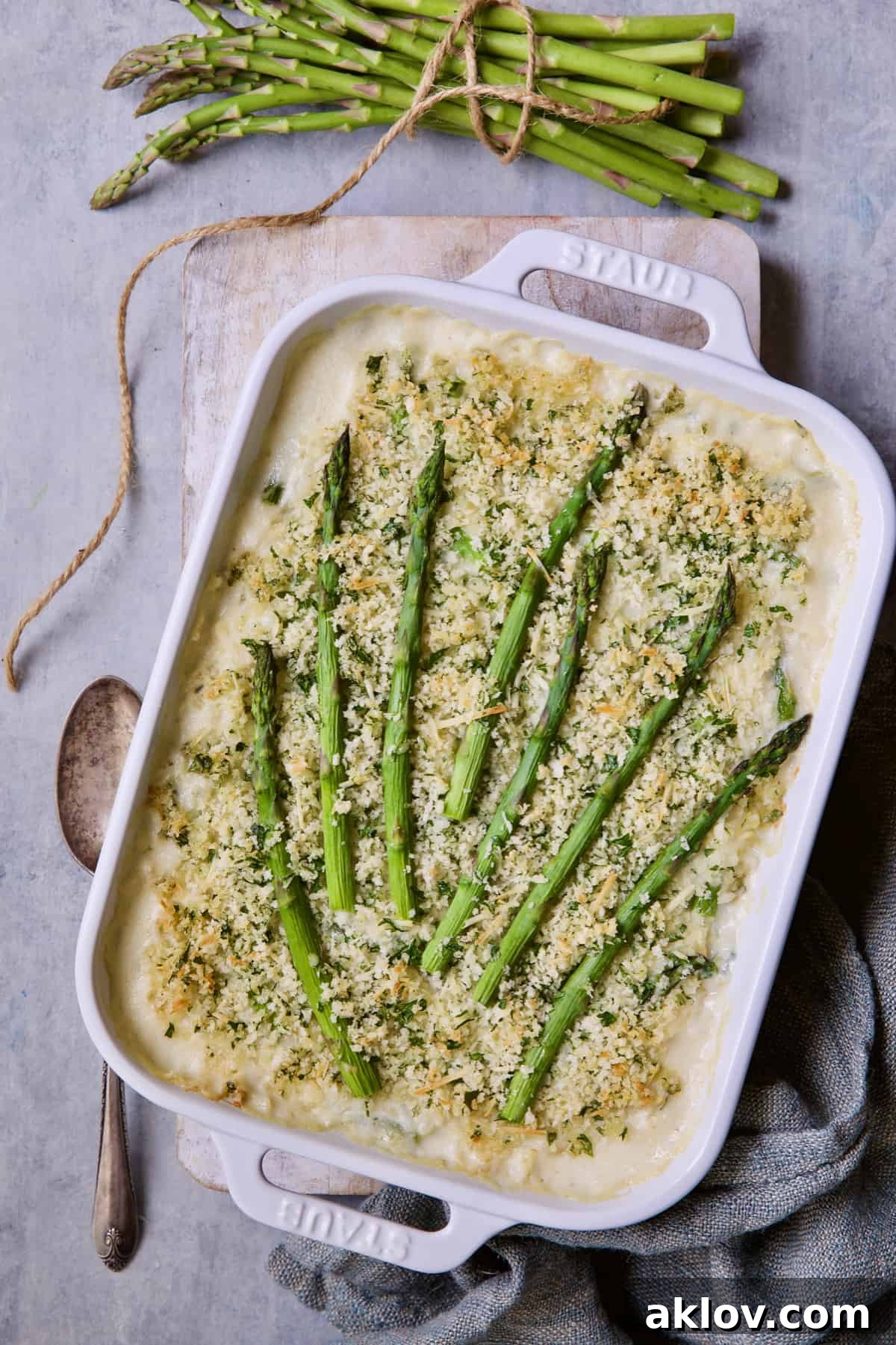 A vibrant and beautifully baked Creamy Asparagus and Rice Casserole, perfectly golden brown and bubbling.
