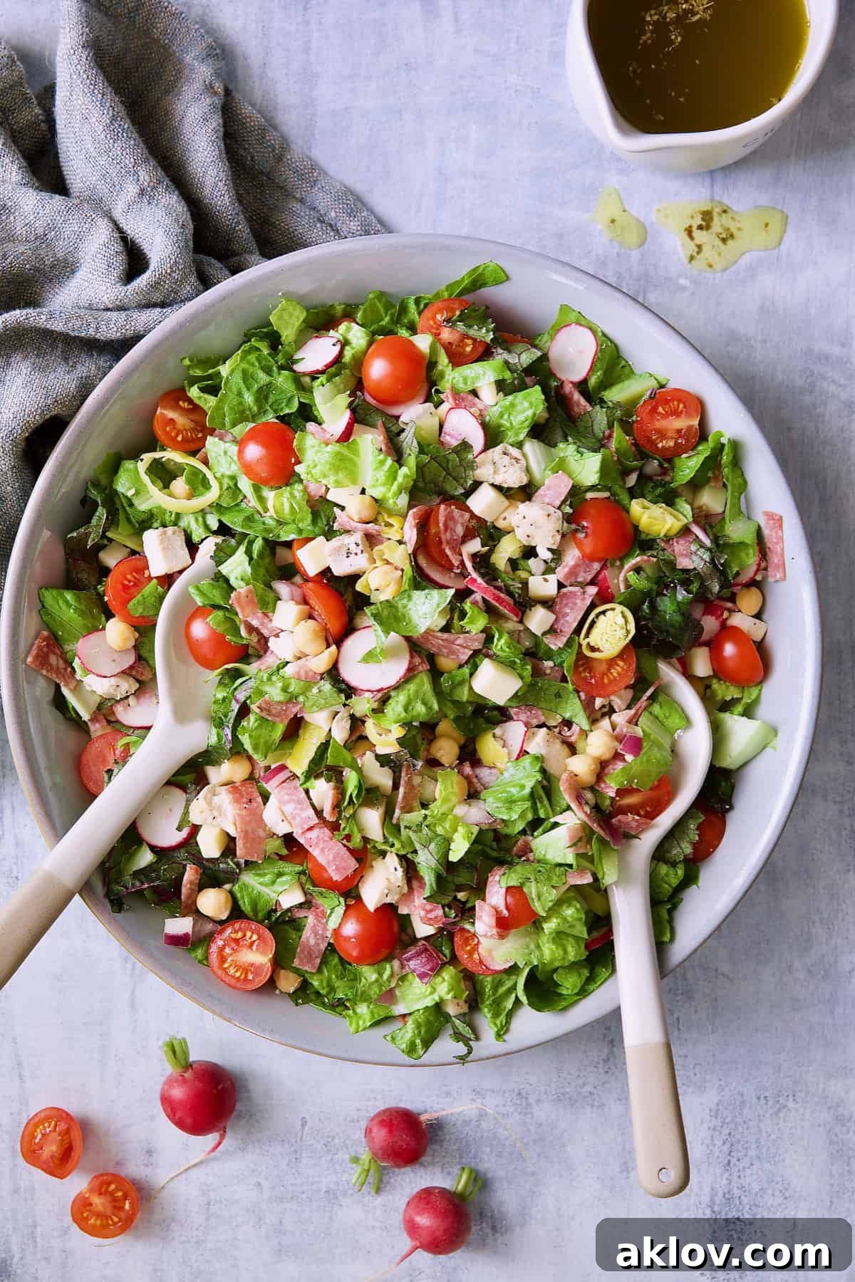 A vibrant Italian Chopped Salad with Chicken, featuring fresh tomatoes and radishes, served in a stylish bowl.