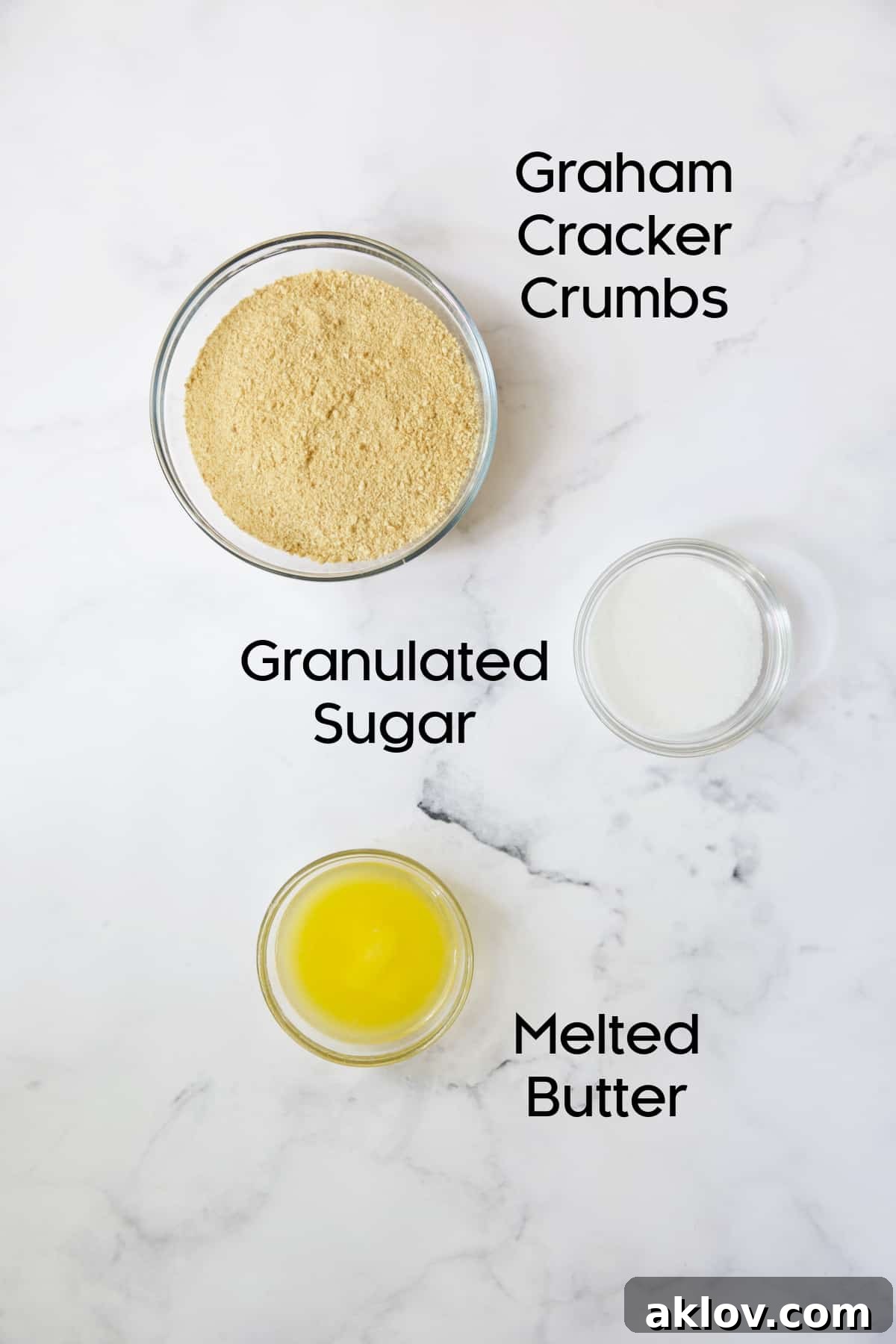 Photo of ingredients for graham cracker crust in glass bowls.
