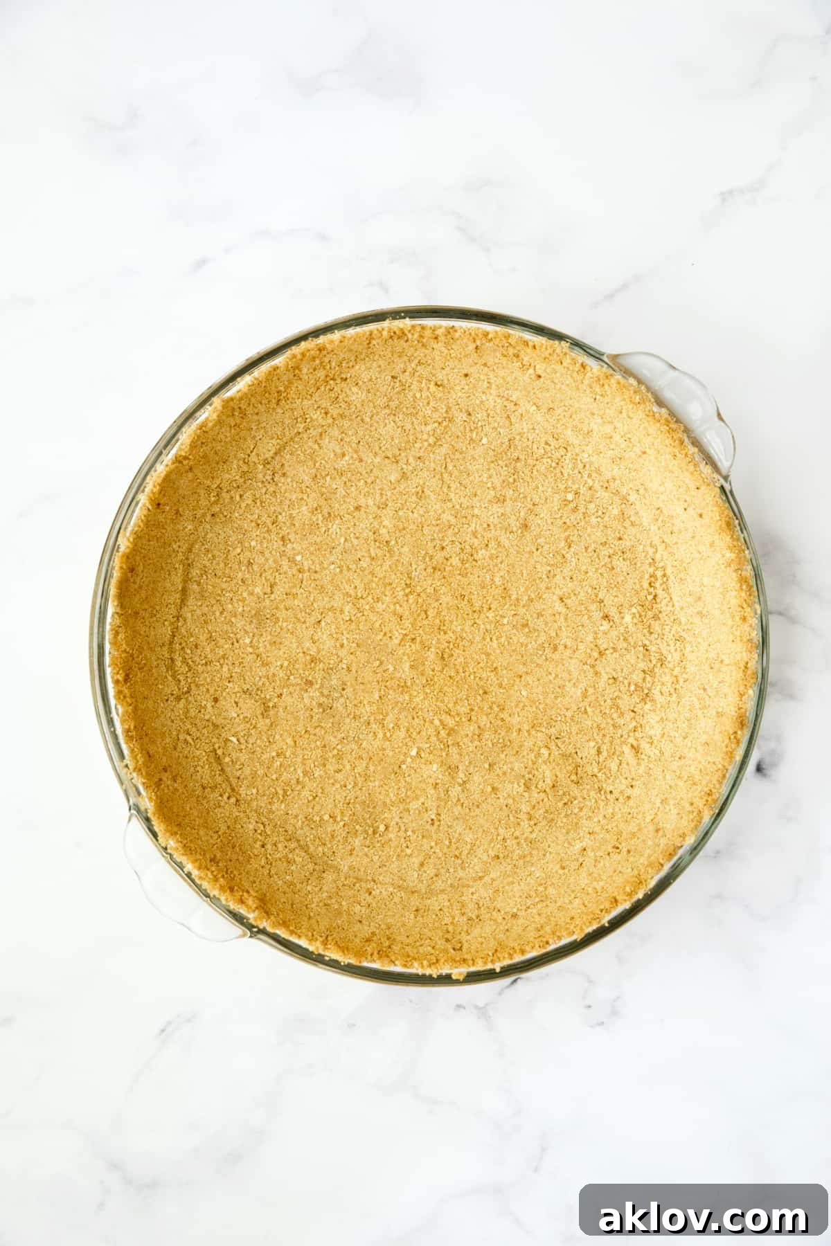 Process photo of unbaked graham cracker crust.