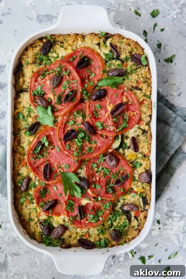 Greek Brown Rice and Vegetable Casserole in white baking dish garnished with fresh parsley.