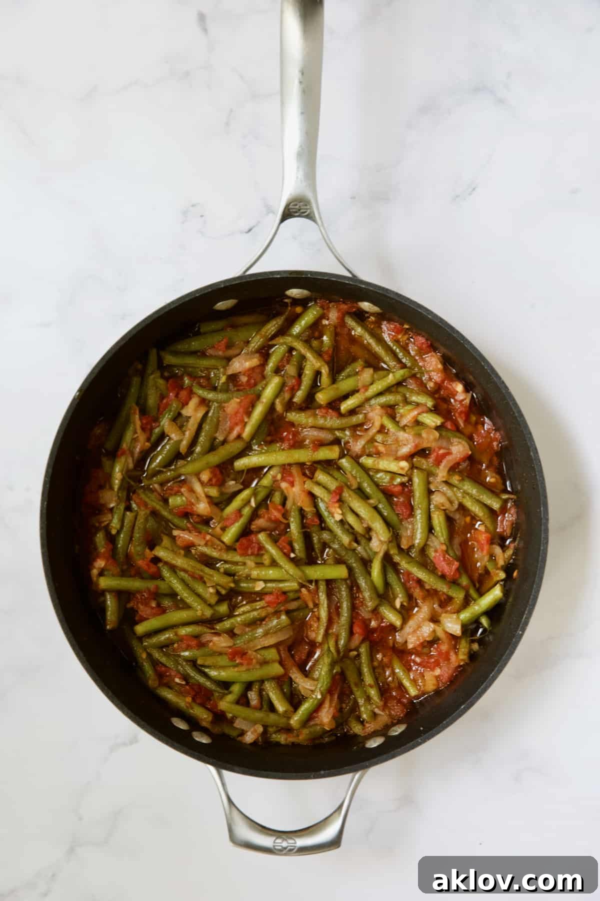 Mediterranean Green Bean and Tomato Stew 11 Cooked green beans and tomatoes in skillet.