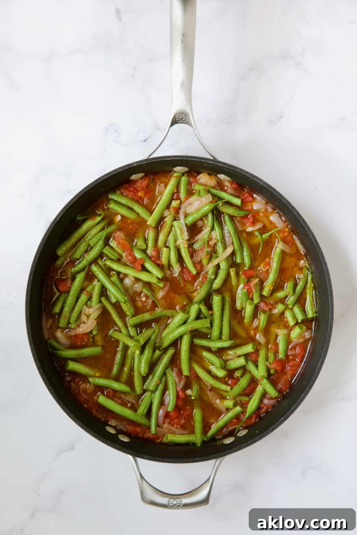 Mediterranean Green Bean and Tomato Stew 10 Green beans and tomatoes cooking in skillet right after fresh green beans are added.