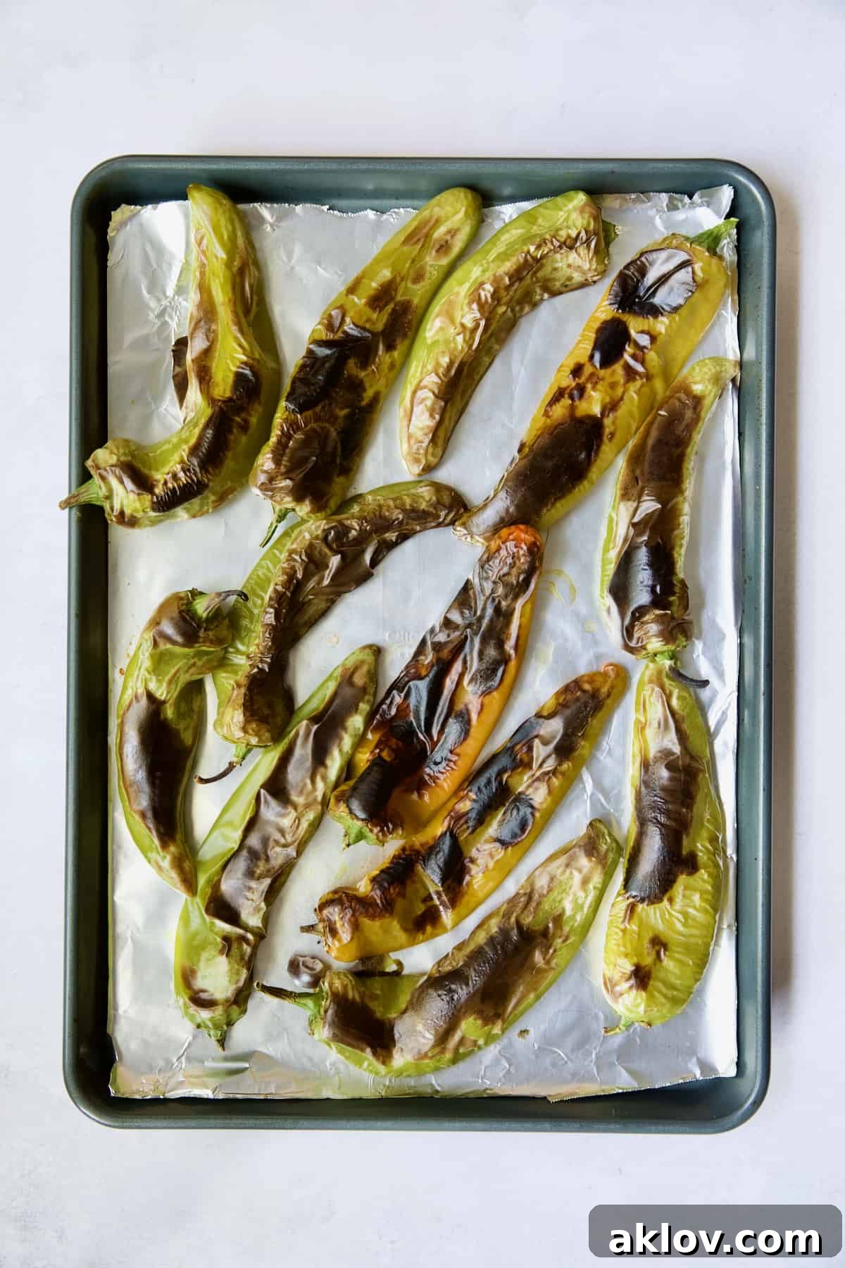 Hatch Green Chiles: Roast and Freeze for Year-Round Enjoyment 7 A sheet pan filled with perfectly roasted and blackened Hatch green chiles, fresh out of the oven.