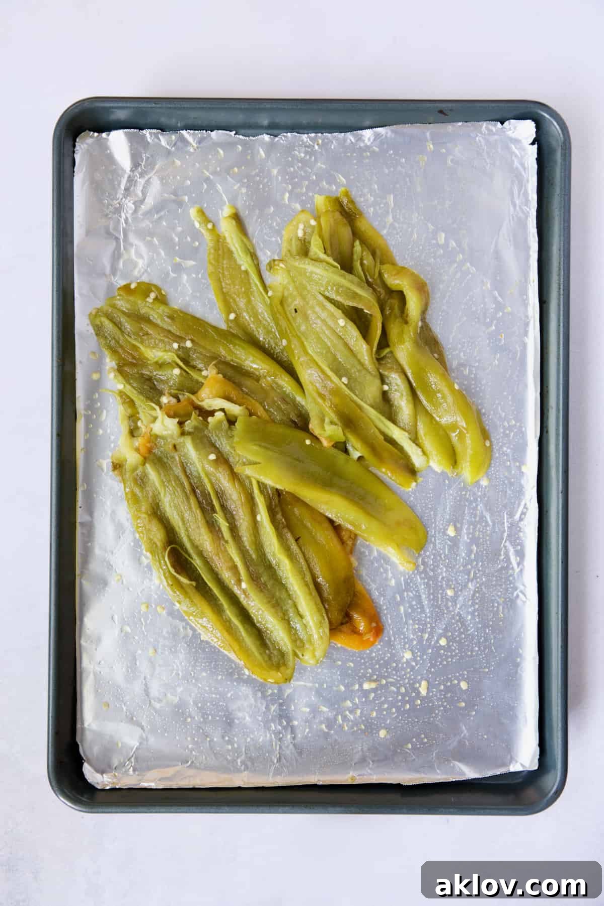 Hatch Green Chiles: Roast and Freeze for Year-Round Enjoyment 10 A generous pile of roasted and seeded Hatch green chiles on a rimmed sheet pan, ready for further preparation.