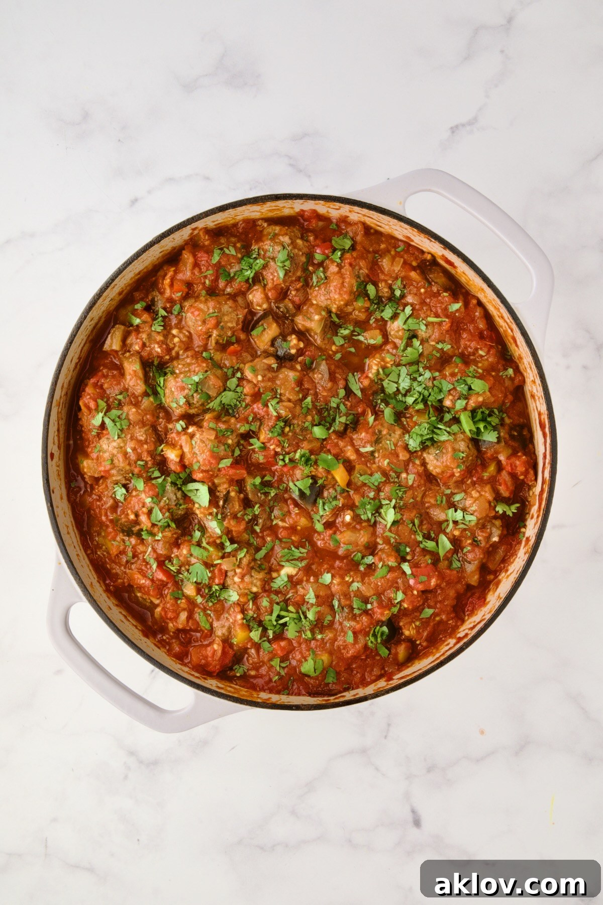 Moroccan Spiced Kofta Stew 18 Moroccan Meatball Stew in white enamel cast iron skillet.