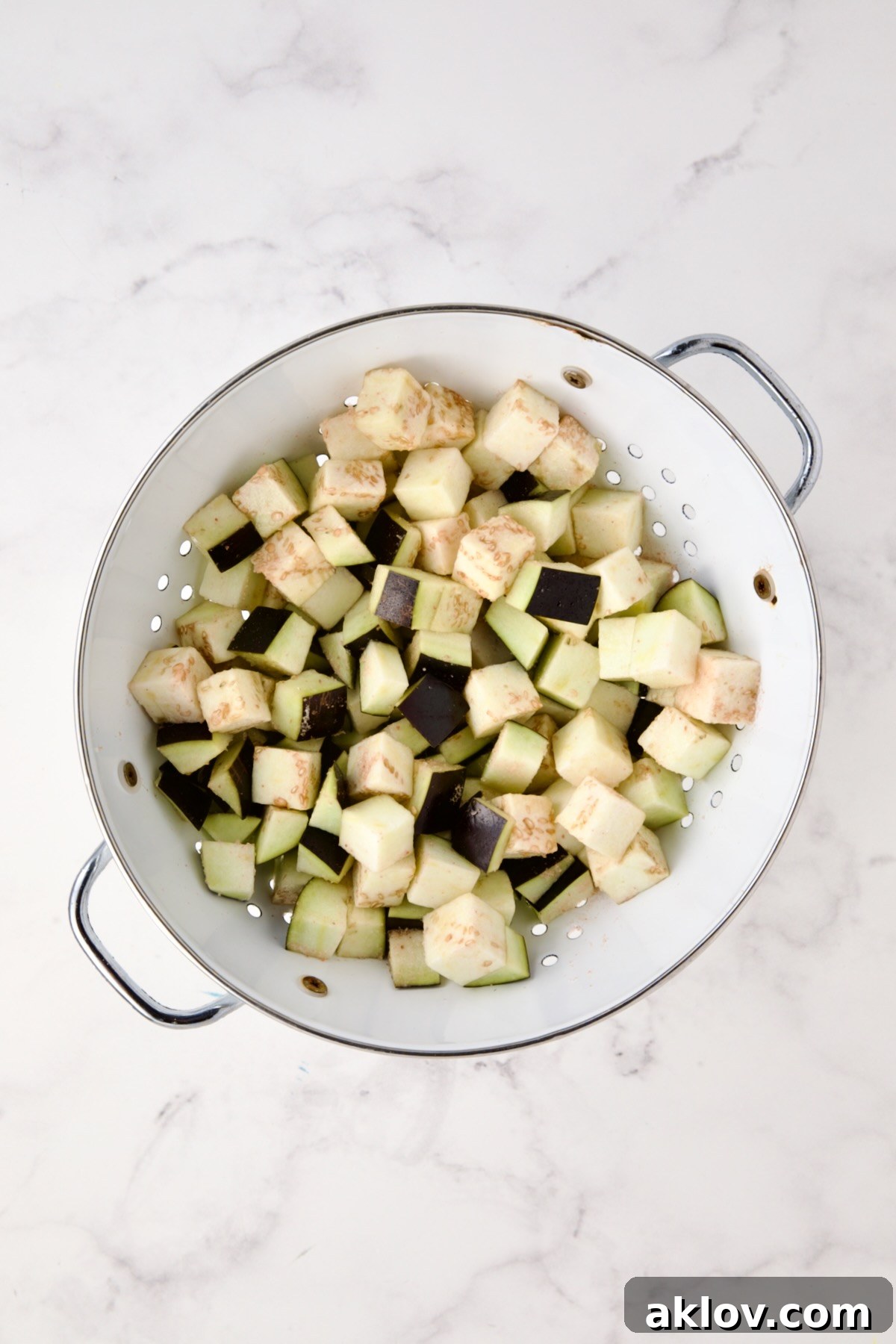Moroccan Spiced Kofta Stew 5 Cubed eggplant in white colander.