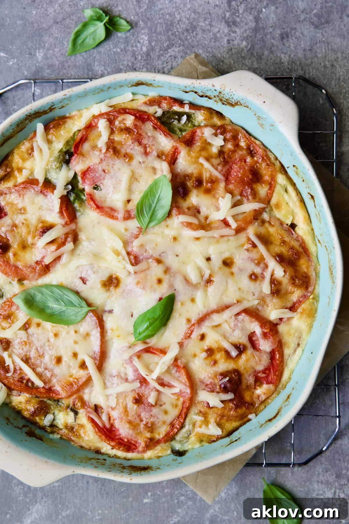 Crustless Southern Tomato Pie in light blue pie pan after being baked.