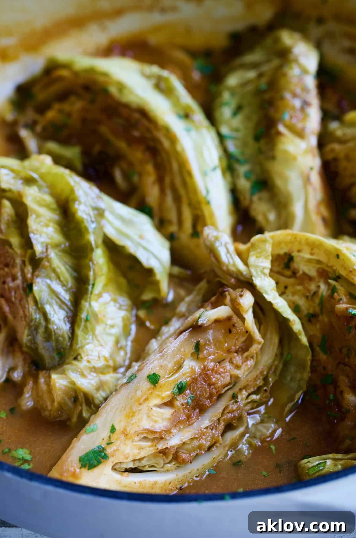 Close-up of perfectly braised Cider Vinegar Cabbage Wedges, tender and glistening, ready to serve.