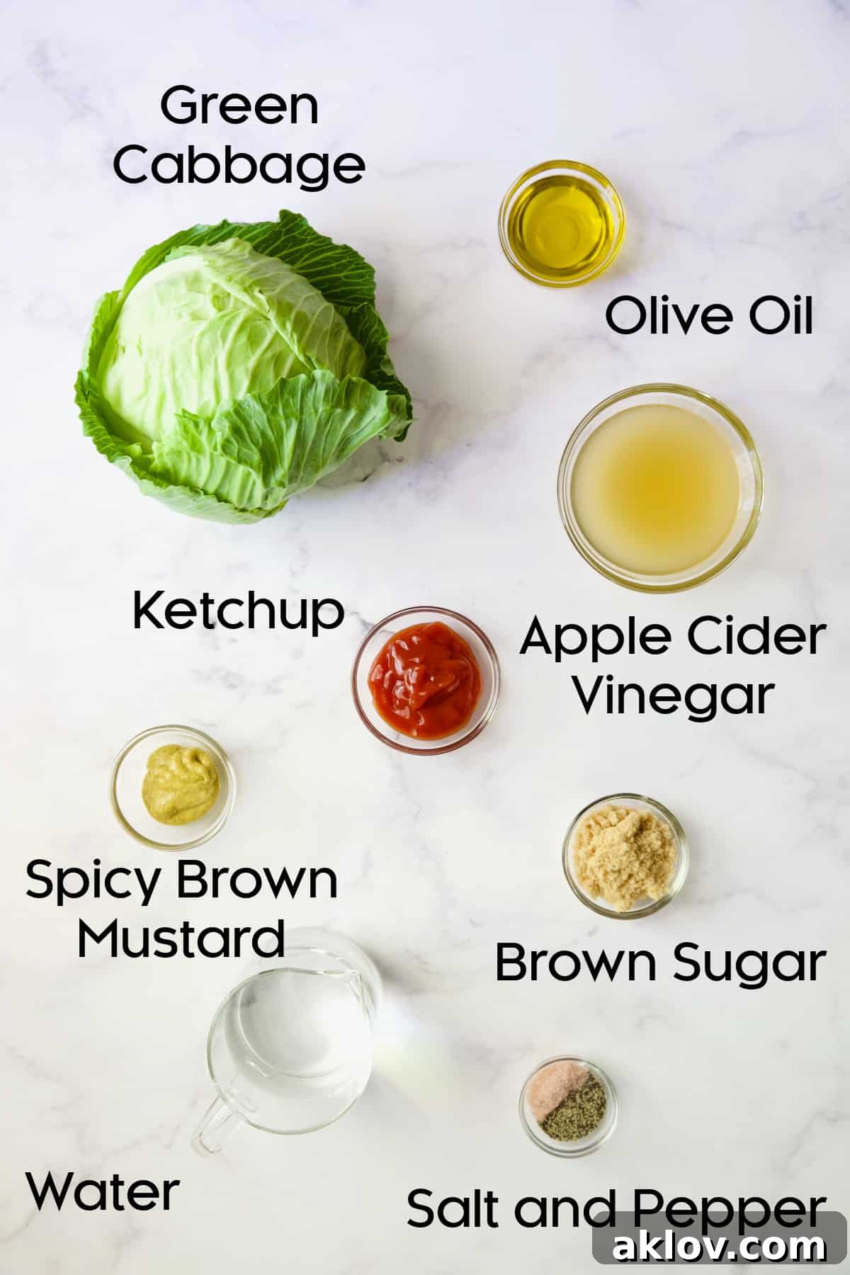 A collection of fresh ingredients for Cider Vinegar Braised Cabbage Wedges, including cabbage, apple cider vinegar, and various seasonings, displayed in glass bowls.
