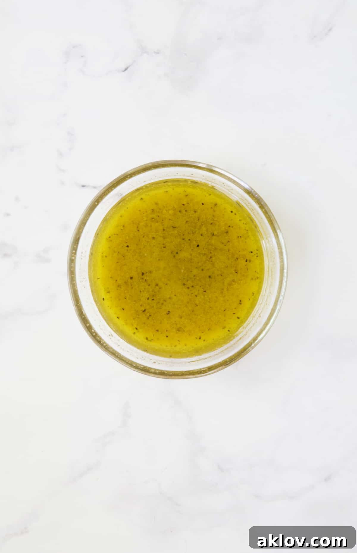 Dressing for Mediterranean Barley Salad in glass bowl.