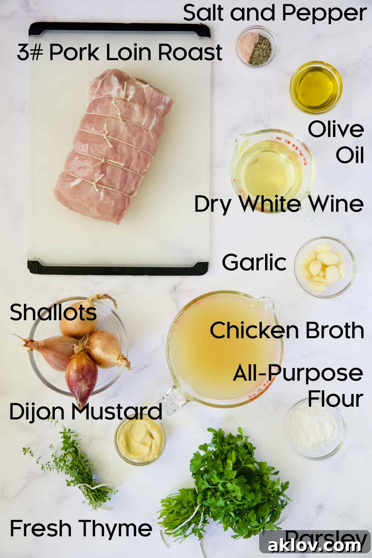 A visual guide to the fresh ingredients required for Braised Pork Loin Roast in Dijon Mustard Sauce, featuring shallots, garlic, thyme, and the main cut of pork.