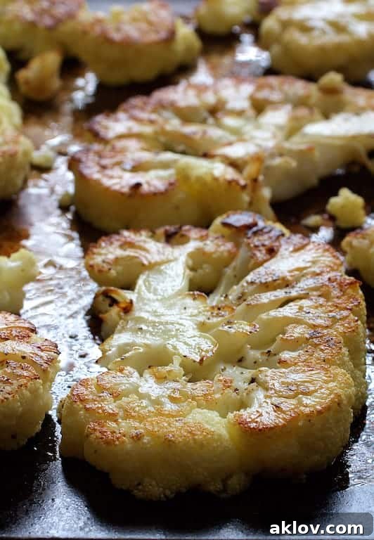 Photo of roasted cauliflower steaks on sheet pan.