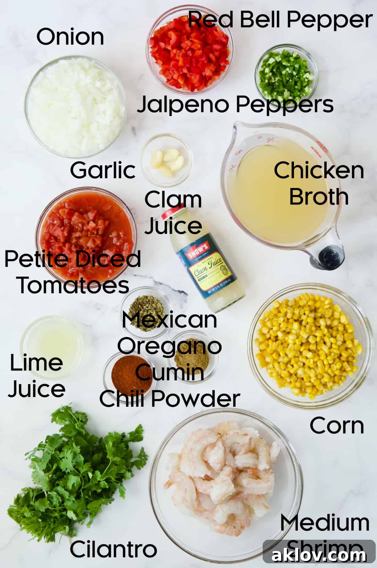 A spread of fresh ingredients for Shrimp and Corn Soup, including colorful bell peppers, jalapeños, onions, garlic, and various spices.