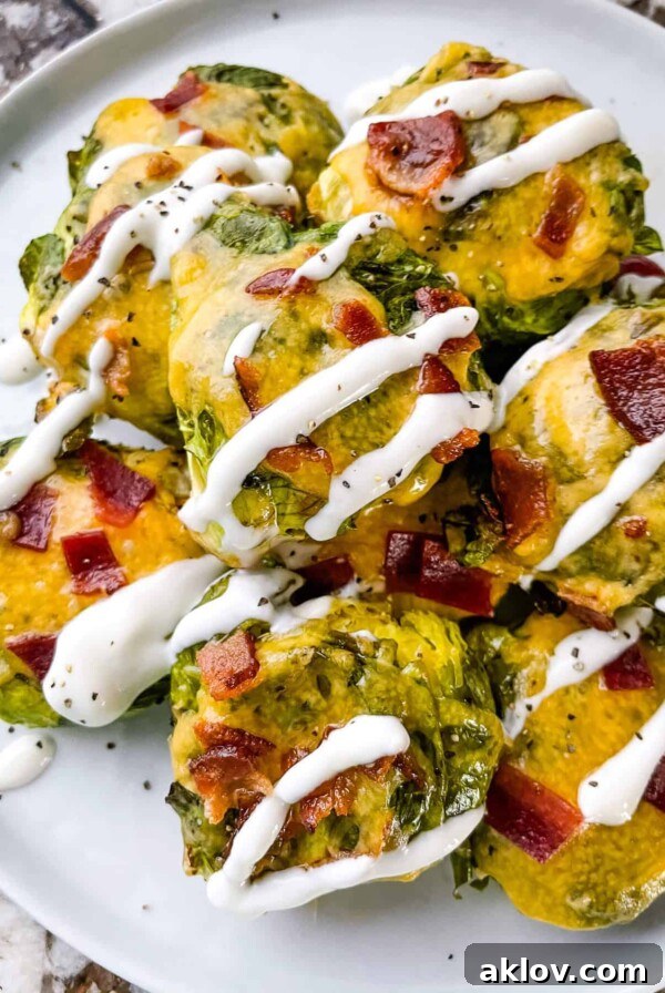 Loaded Smashed Brussels Sprouts, topped with cheese, bacon, and chives.