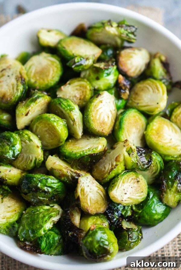 Air Fryer Brussels Sprouts in a round white serving bowl, showing their crispy exterior.