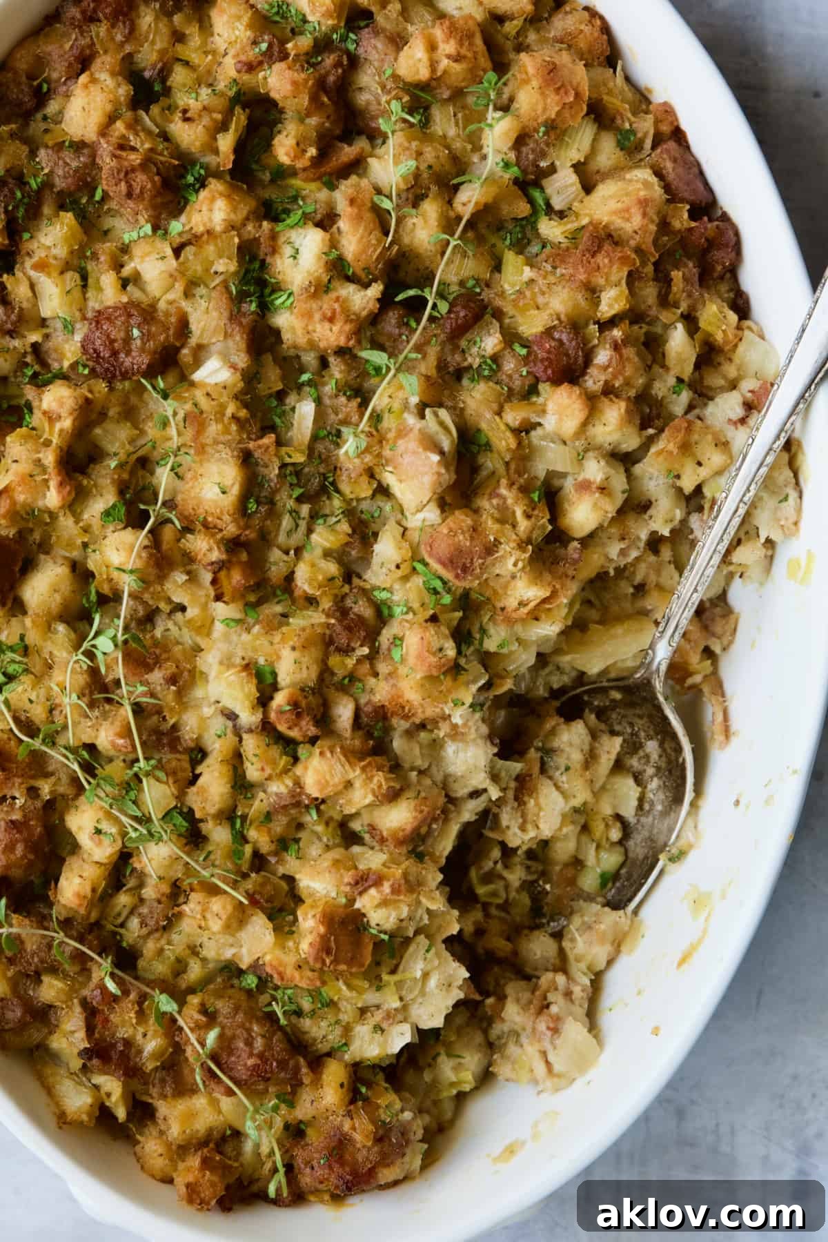 Aromatic Fennel and Leek Sausage Stuffing 2 Sausage Stuffing with Fennel and Leeks in a white oval gratin dish, served with a spoon. A perfect holiday centerpiece.
