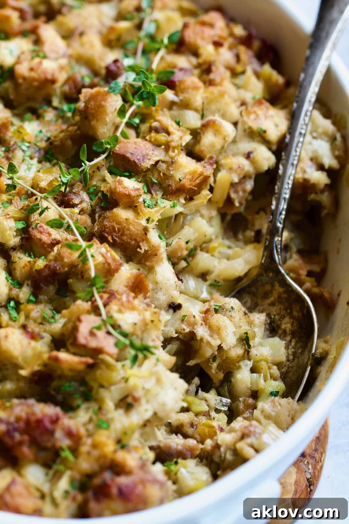 Aromatic Fennel and Leek Sausage Stuffing 14 Sausage Stuffing with Fennel and Leeks beautifully presented in a white oval gratin dish, with a serving spoon.