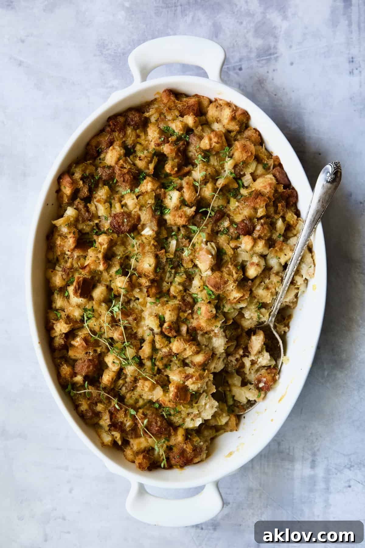 Aromatic Fennel and Leek Sausage Stuffing 15 Baked Sausage Stuffing with Fennel and Leeks in a white oval gratin dish, perfectly golden and ready to serve.