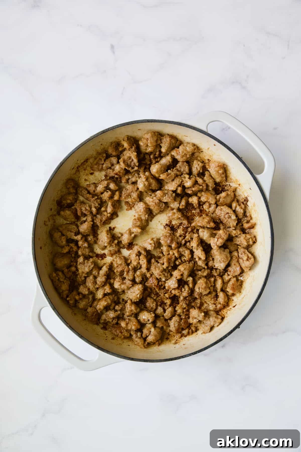 Aromatic Fennel and Leek Sausage Stuffing 6 Crumbled, cooked Italian sausage in a white enamel cast iron skillet.