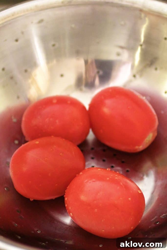 Pan-Seared Scallops with Vibrant Balsamic Tomato Salsa 13 Photo of four tomatoes in stainless steel colander.