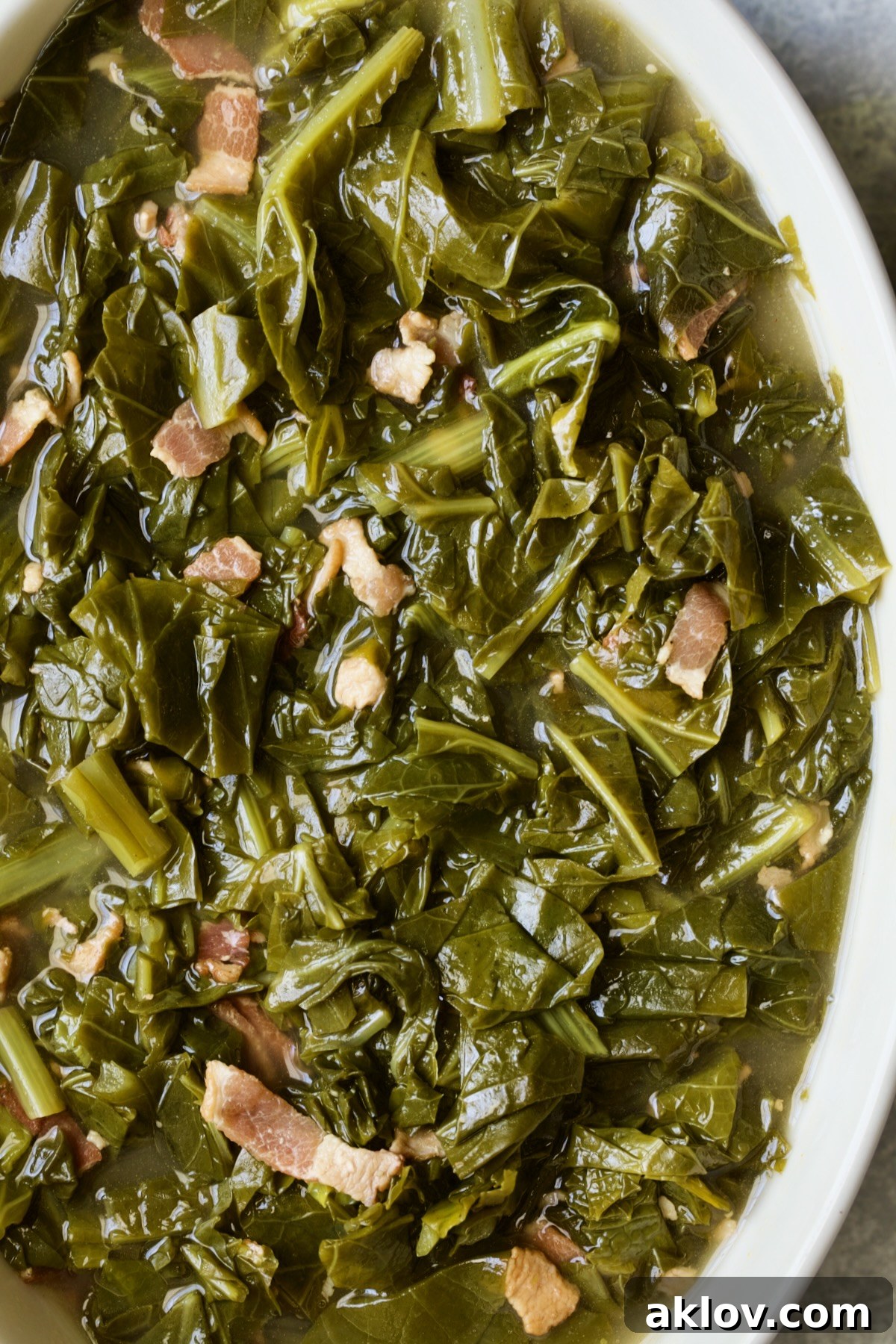 Braised Southern Greens in white oval serving bowl.