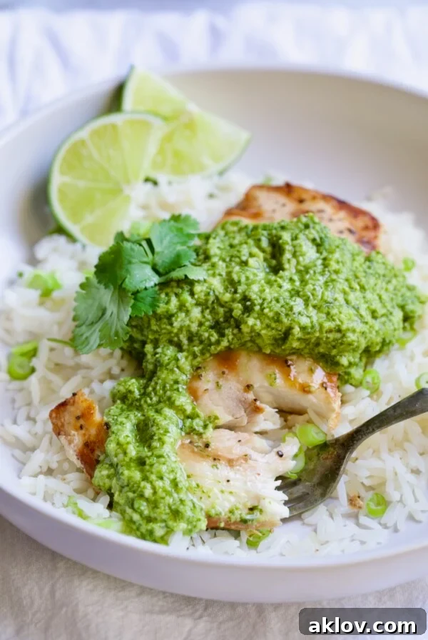 Close-up of a tender piece of Mahi Mahi with Cilantro-Ginger Pesto on a fork, ready to eat.