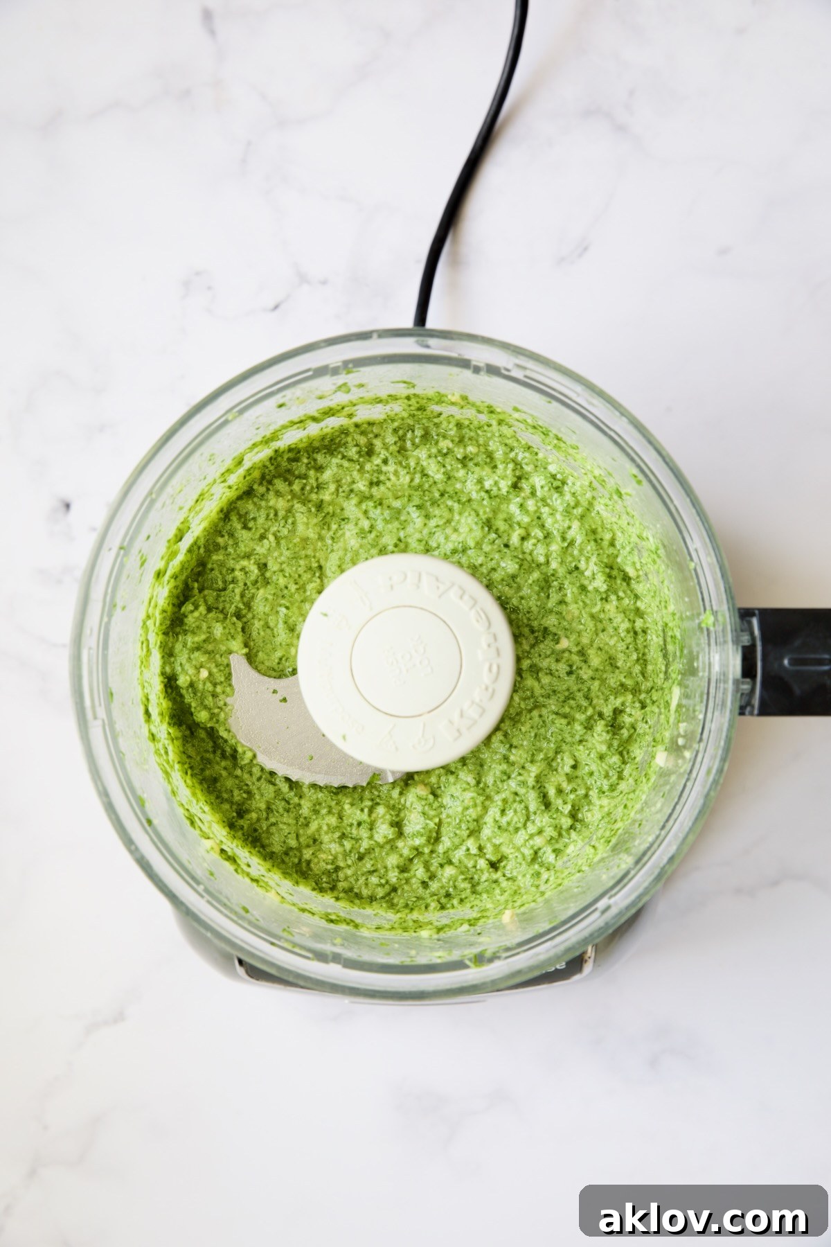 The finished, smooth, and vibrant Cilantro-Ginger Pesto, expertly blended in a food processor, ready to be paired with grilled Mahi Mahi.