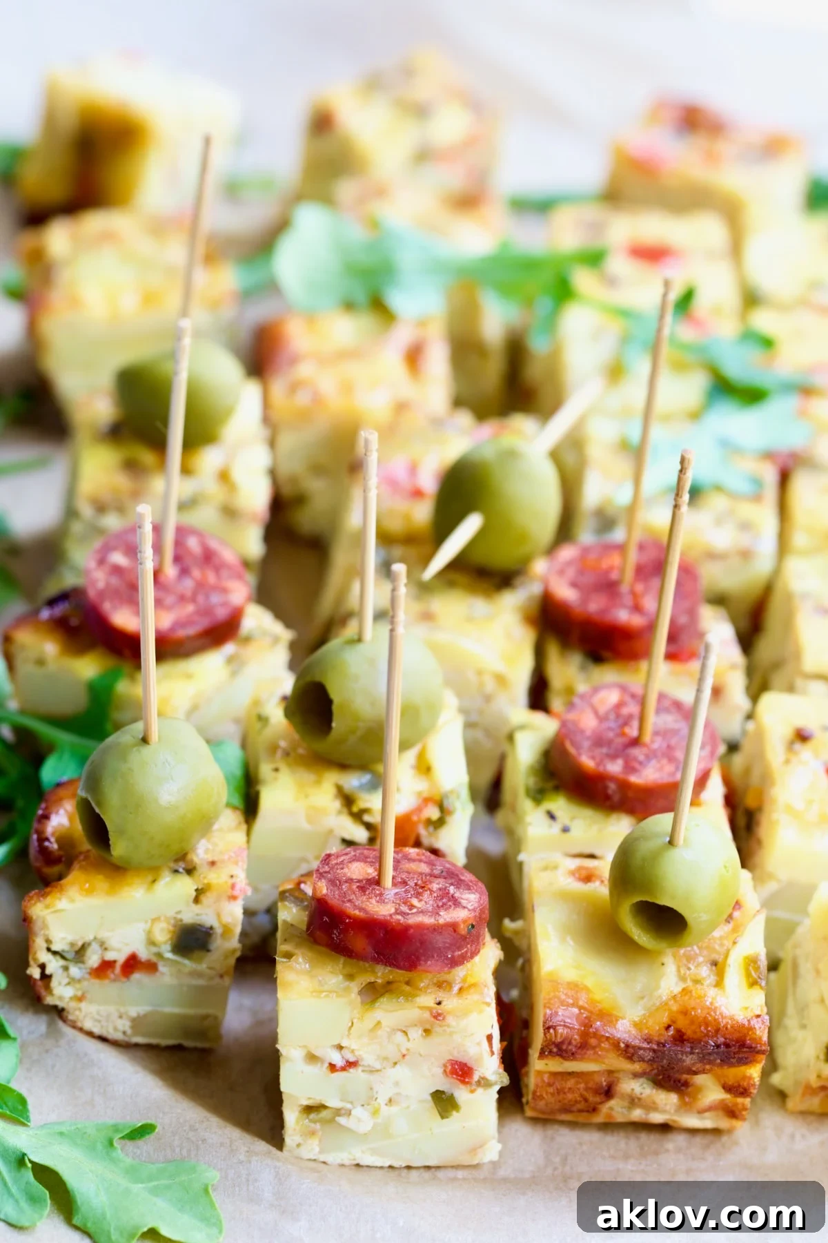 Cubes of Oven-Baked Spanish Tortilla garnished with chorizo and olives.