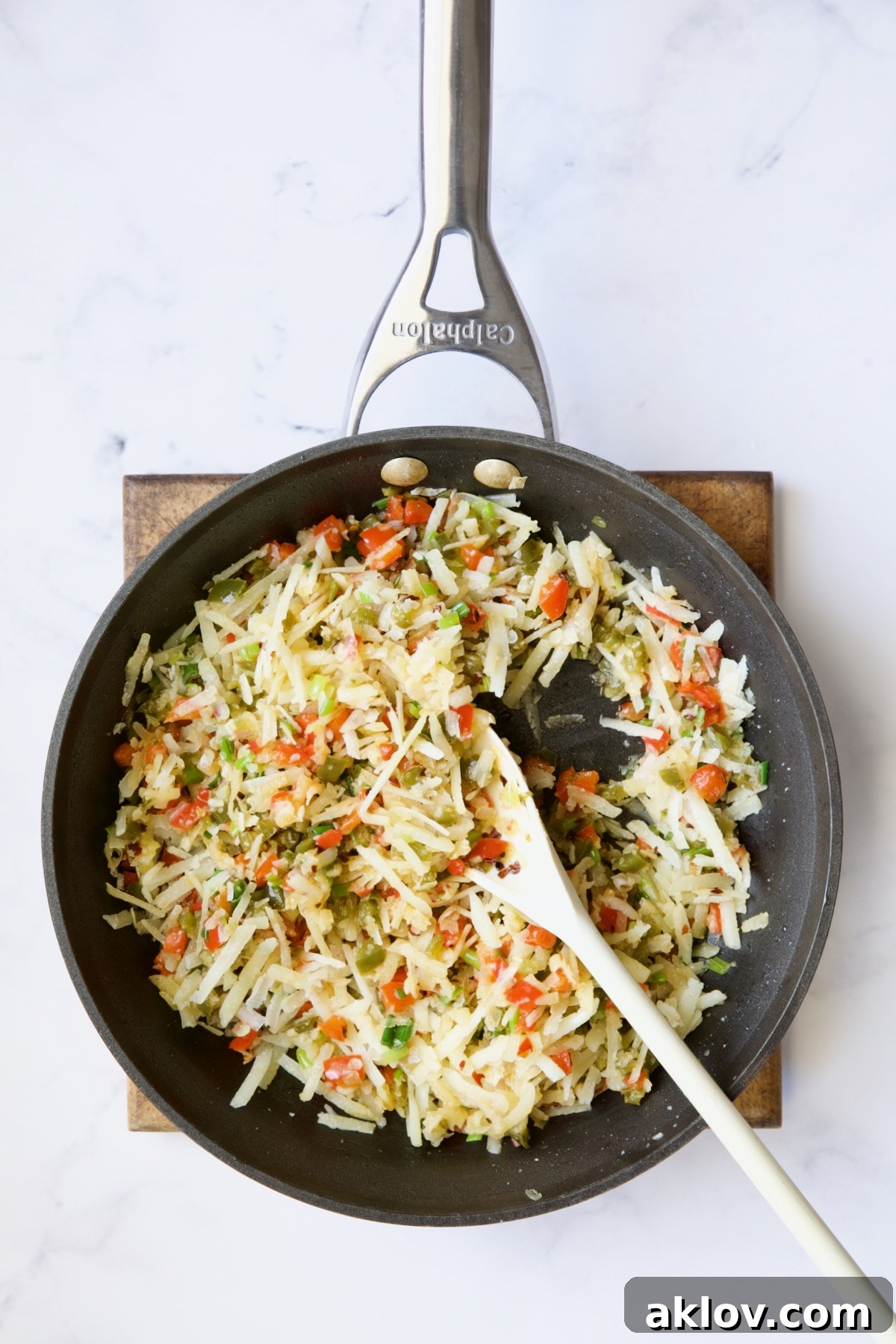 Peppers, onions and cheese in nonstick skillet.