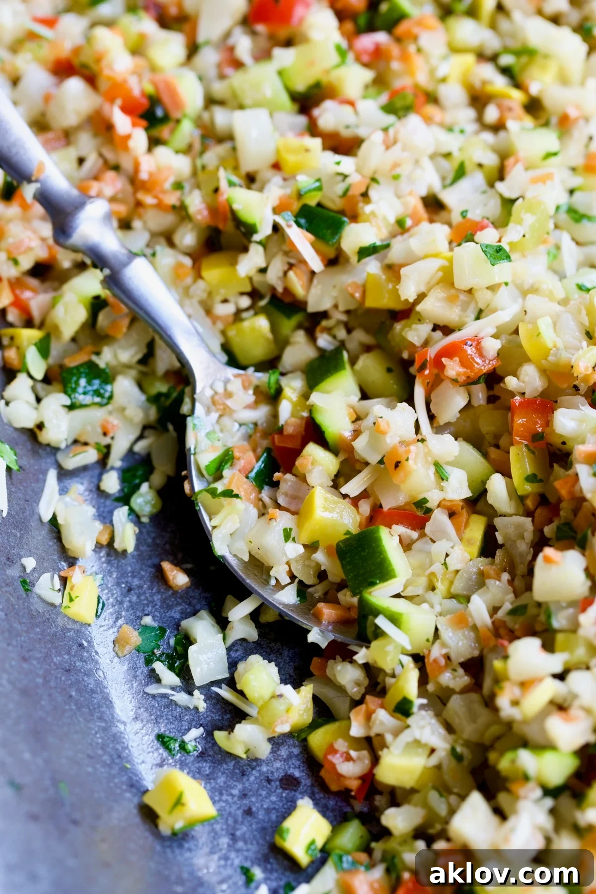 Garlic Parmesan Roasted Riced Veggies 12 A spoonful of Garlic Parmesan Roasted Riced Vegetables, showcasing its texture and ingredients.