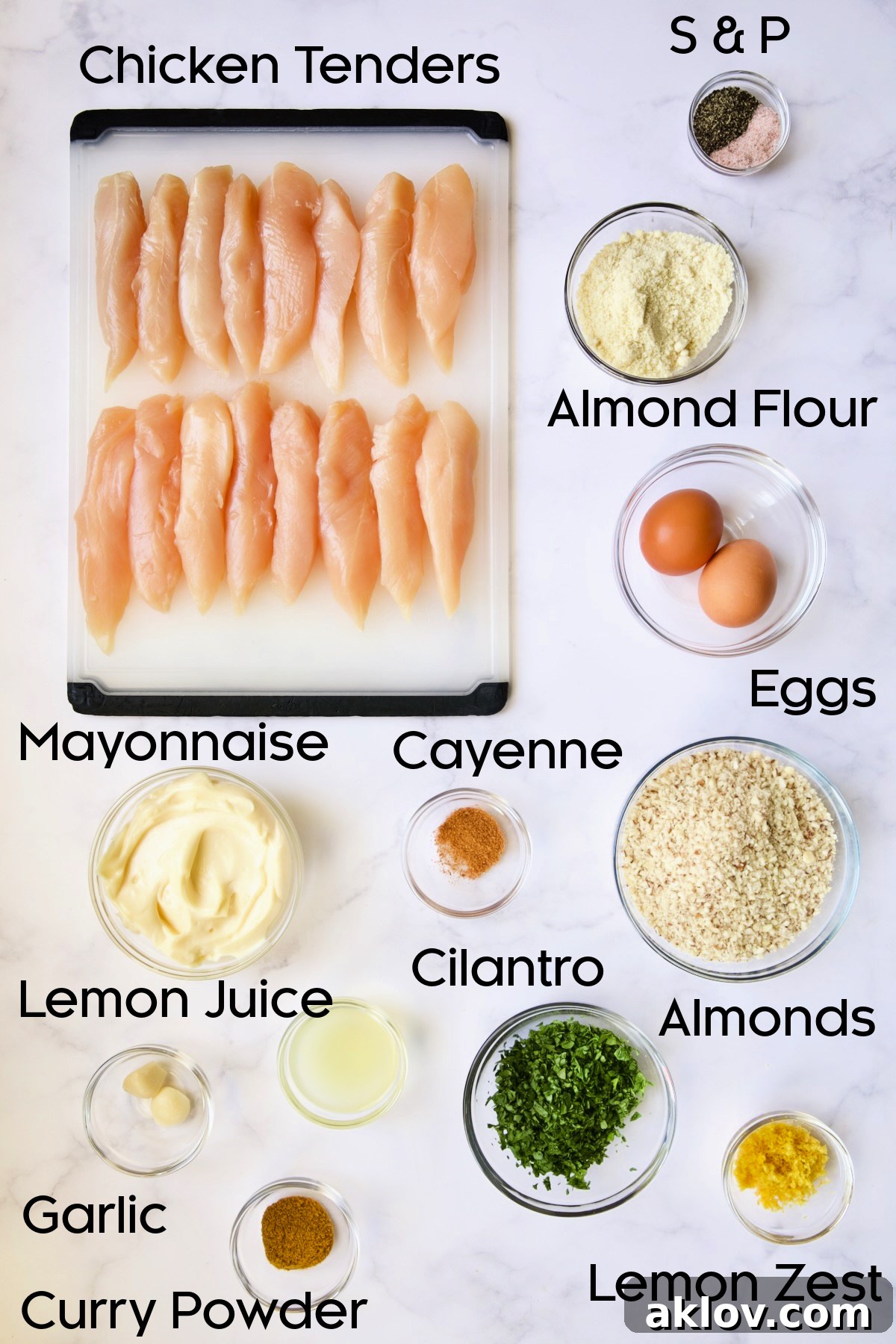 Ingredients for Almond-Crusted Chicken Tenders with Lemon Curry Mayonnaise in glass bowls.