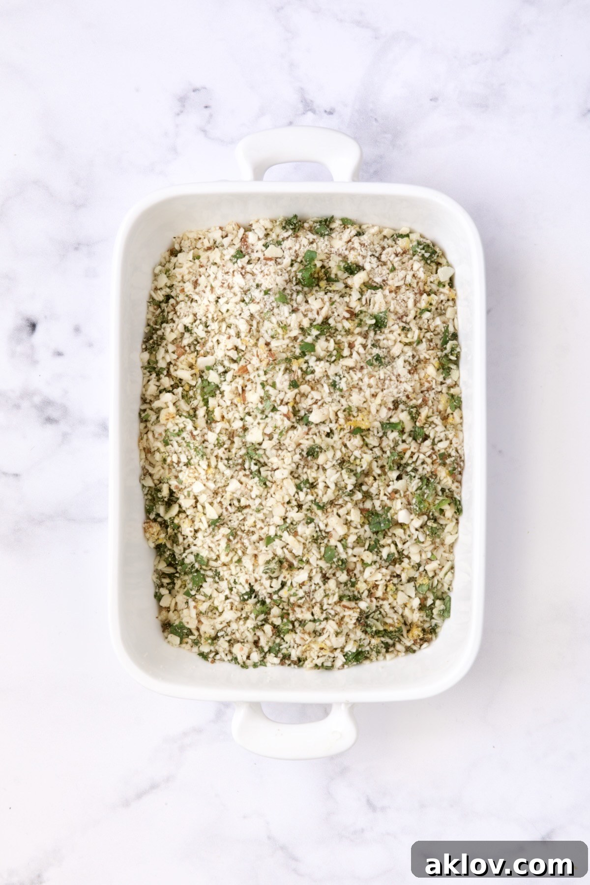 Almond coating in white rectangular baking pan.